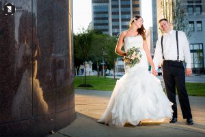 Bride and groom in sun outside Buffalo Public Library
